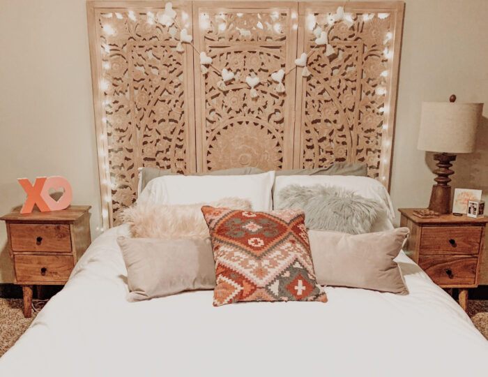 Pillows on the bed with a folding screen headboard