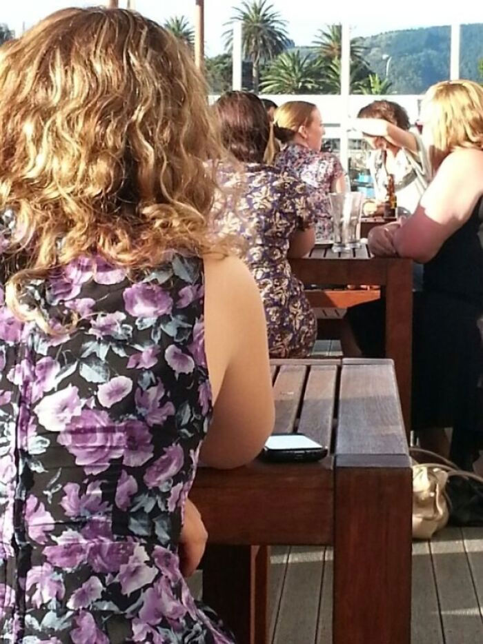 At The End Of These Three Different Tables, These Women Were Wearing Similar Floral Purple Dresses