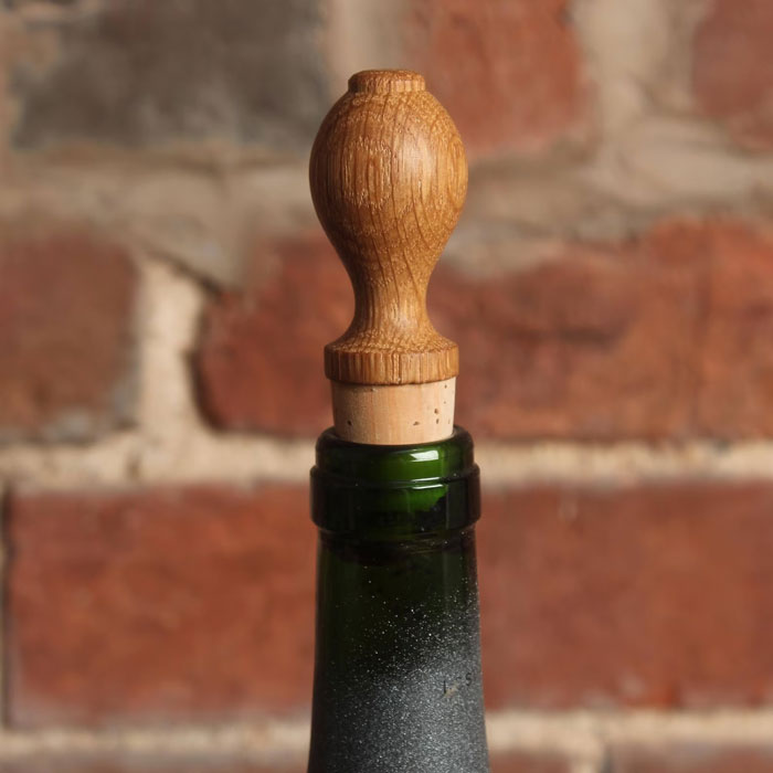 Oak Wine Bottle Stopper: That adds a charming, rustic finish to your favorite wine while keeping it fresh, because who wouldn't want their fine wine complimented with a touch of stylish elegance?