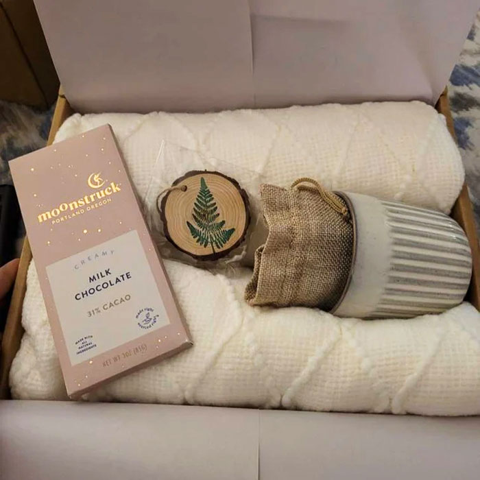 Hygge Gift Box: Packed with comfort essentials like a soft throw blanket, hot beverage options, and gourmet chocolate, perfect for gifting someone special or practicing self-love.