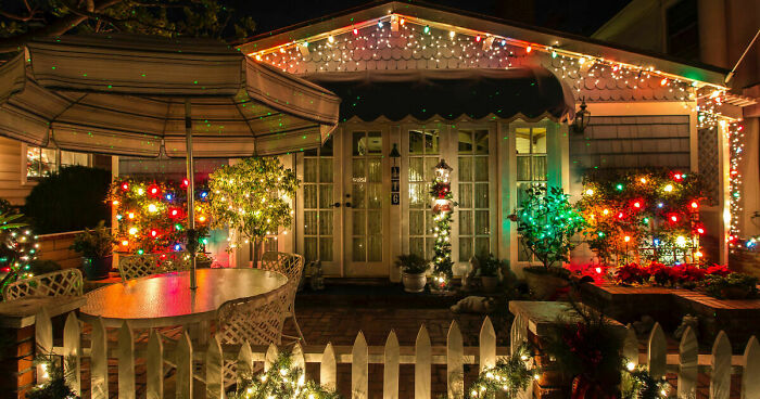 House exterior decorated with affordable Christmas decor featuring colorful string lights and festive outdoor ornaments.