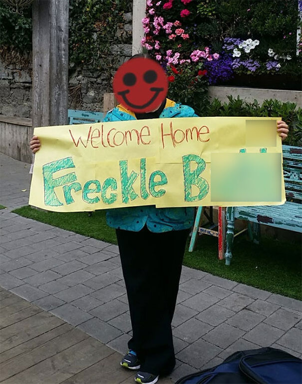 Girl holding a welcome sign 