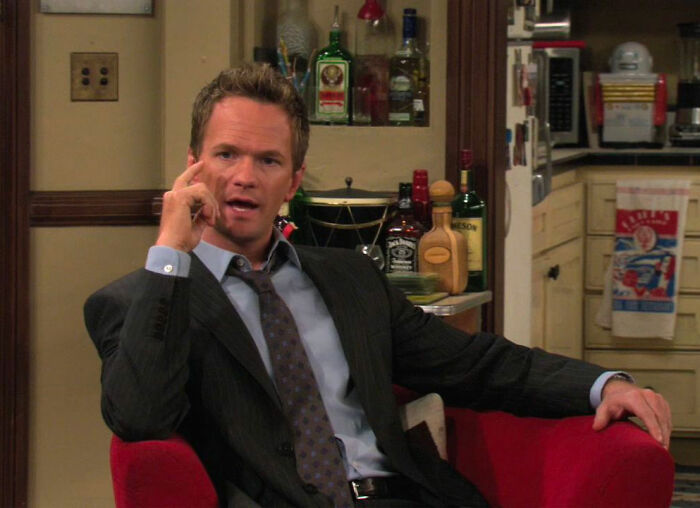 Barney Stinson sitting and talking from How I Met Your Mother