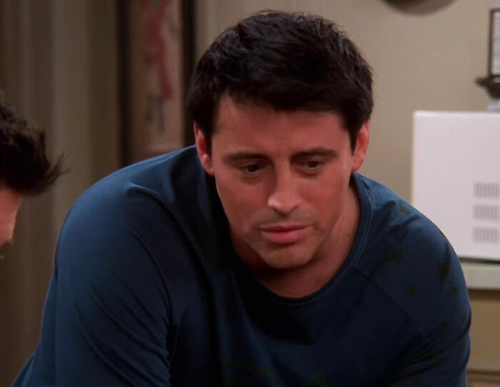 Joey Tribbiani wearing blue clothes and looking from Friends