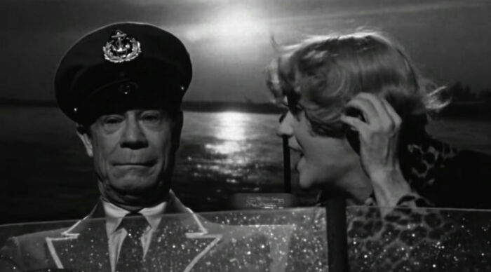 Osgood Fielding III swimming with boat and talking with woman from Some Like It Hot