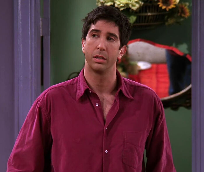 Ross Geller wearing pink shirt and looking from Friends