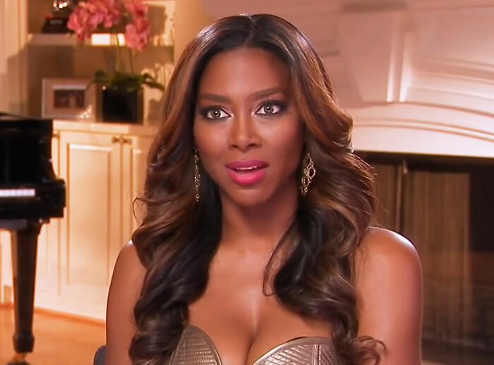 Kenya Moore wearing dress sitting and talking from The Real Housewives of Atlanta