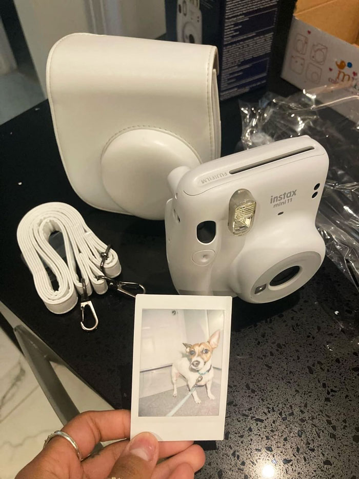 Fujifilm Instax Mini 11 Instant Camera: Perfect for the trendy selfie-lover in your life, adds a fun vintage vibe to any moment with its cool transparent ring lens, automatic exposure for bright shots, and customizable shutter buttons.