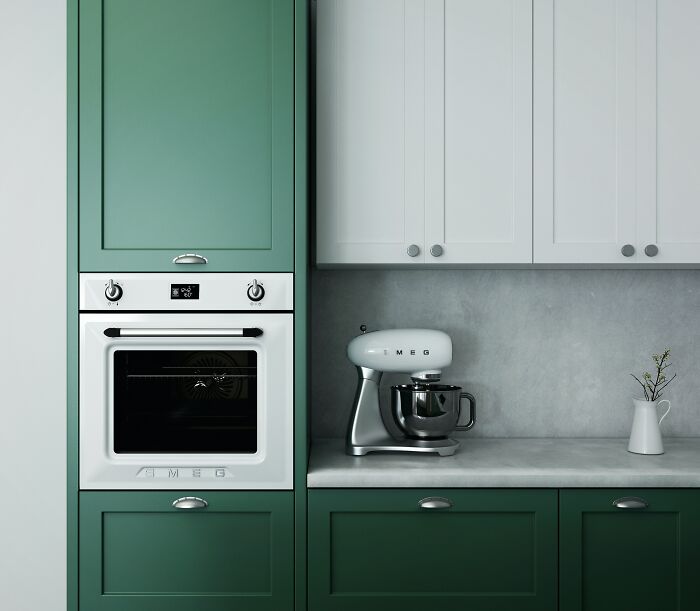 Green and white kitchen with cabinets