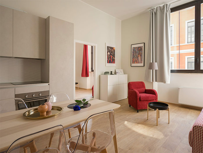 White tidy room filled with white and red furnitures White tidy room filled with white and red furnitures