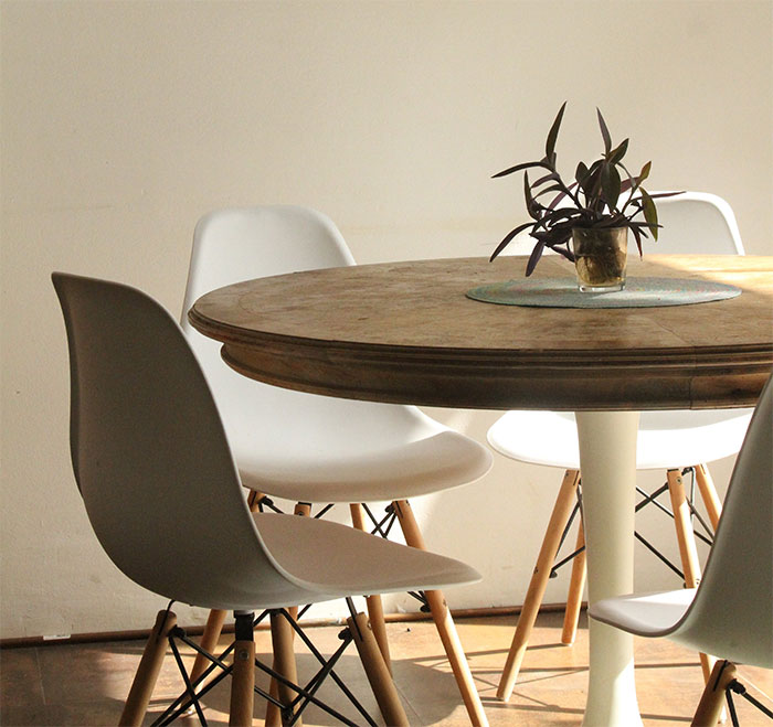 Room with empty white chairs beside table Room with empty white chairs beside table