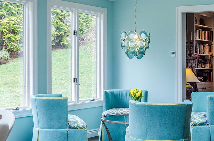 Light blue room with blue chairs and a table