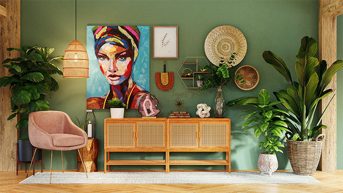 A green room with many paintings, plants, and pieces of furniture
