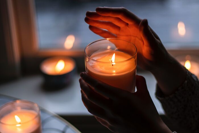 Woman holding lighted candle
