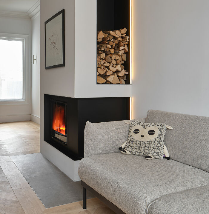 White room with fireplace and gray couch 