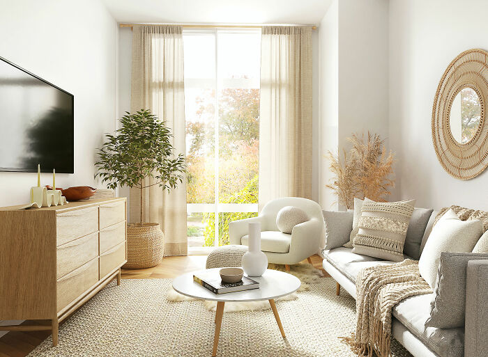 White room with white couch brown rug and cupboard with tv