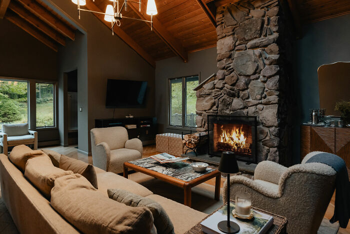 A living room filled with brown couch and a fireplace