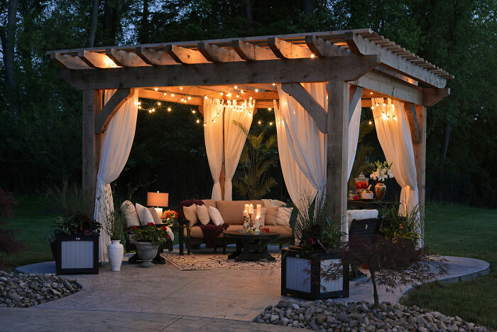 Pergola with fairy lights and furniture