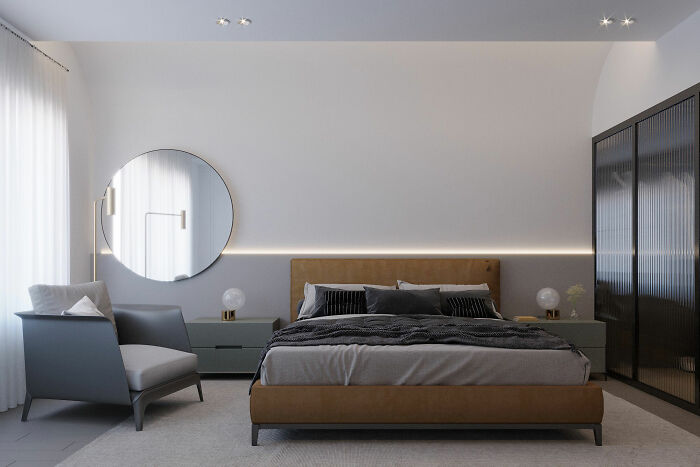 Gray bedroom with brown bed, sofa, cupboard and mirror