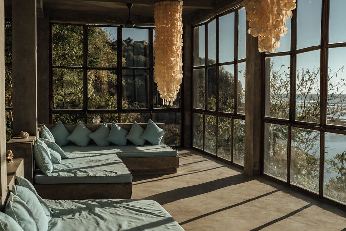 A room with big windows and a couch