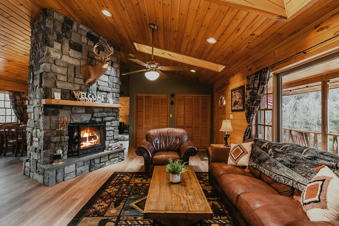 A rustic living room filled with furniture and a fireplace