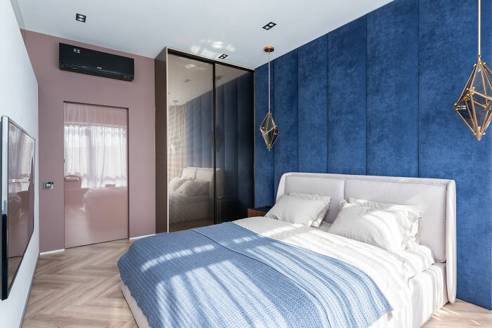 Room with blue decor and bed with blue sheets