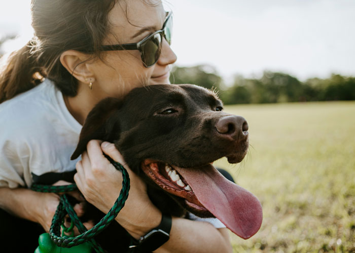 Woman hugging a dog Woman hugging a dog