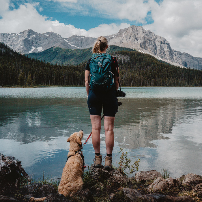 Woman hiking with her dog Woman hiking with her dog