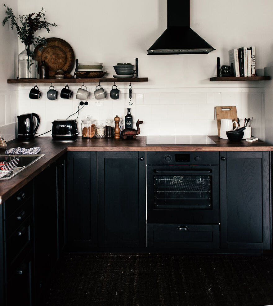 Black kitchen with great amount of different appliances