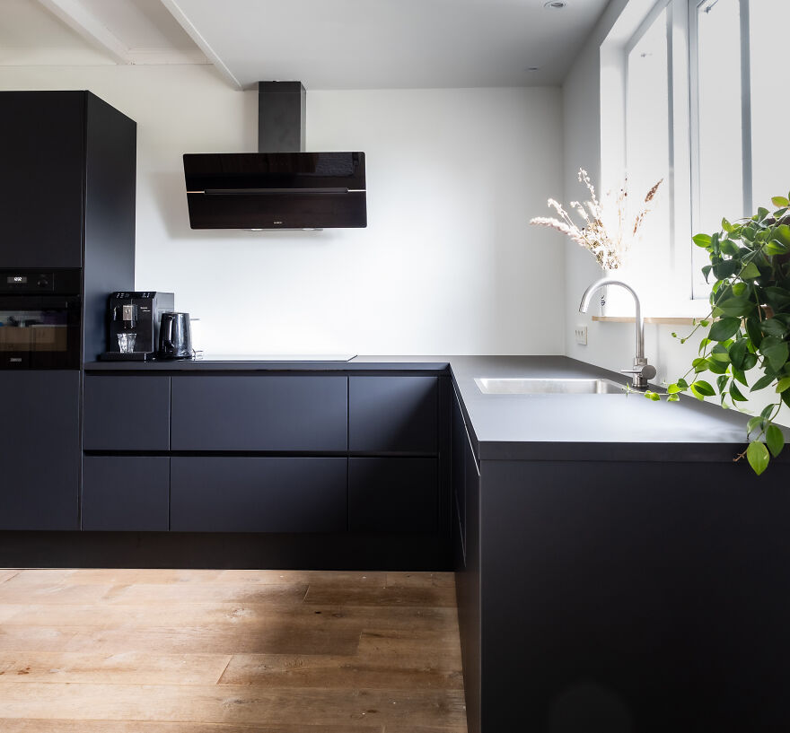 Black kitchen cabinets on the backgrounds of white walls