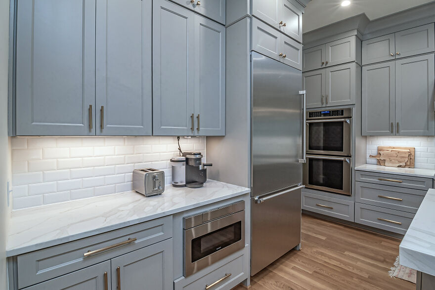 Coffee maker and toaster in white and gray kitchen