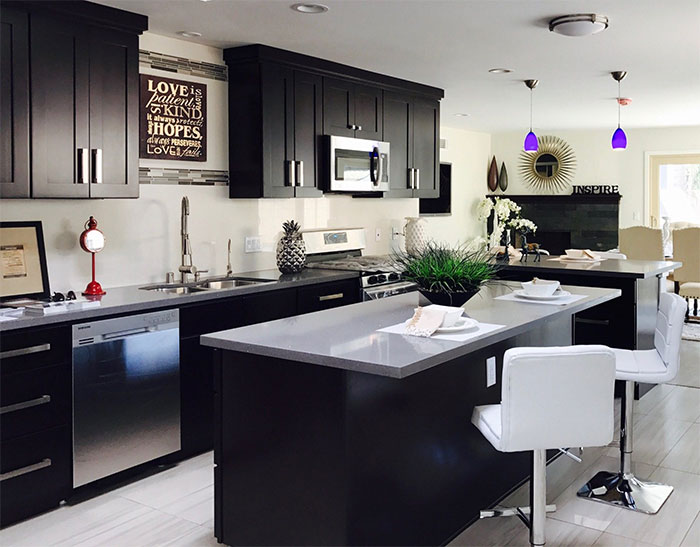 Black kitchen with white marble countertop