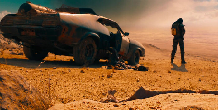 Car and man on the road in movie Mad Max: Fury Road