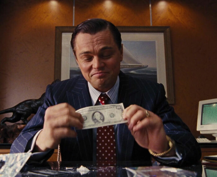 Jordan Belfort holding money from The Wolf of Wall Street