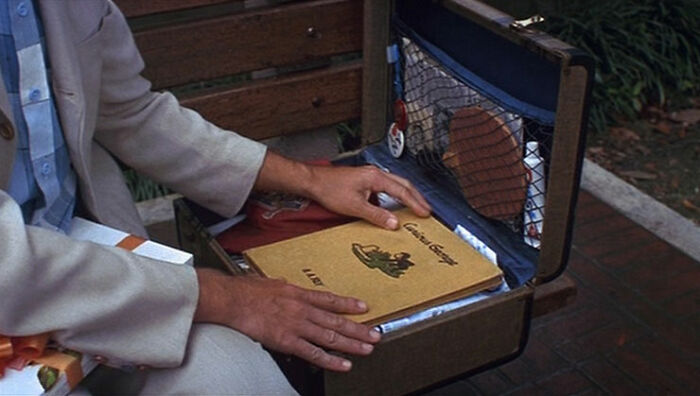 Forrest Gump holding book in the suitcase