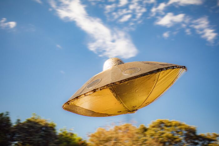 Golden yellow UFO in the sky 