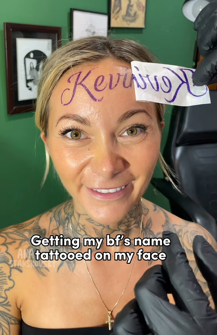 Influencer with fake tattoo of boyfriend's name on forehead in a tattoo studio setting. Influencer with fake tattoo of boyfriend's name on forehead in a tattoo studio setting.