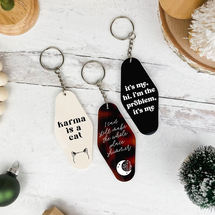 Taylor Swift Midnights Keychain: Add some class to their set of keys with this engraved and hand-painted acrylic keychain inspired by Taylor Swift's Midnights album.
