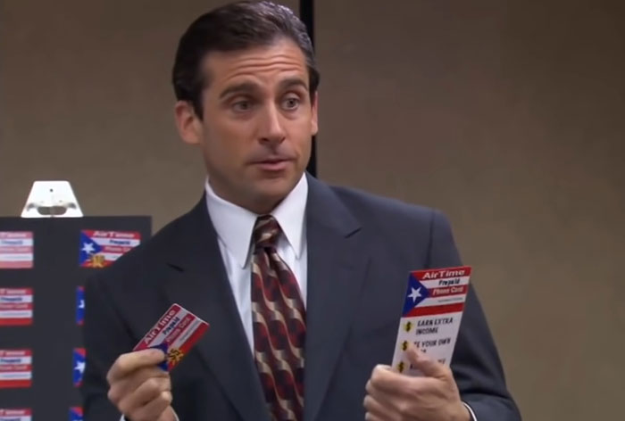 Michael Scott talking and holding flyer