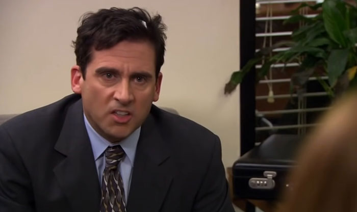 Michael Scott looking mad with curly hair