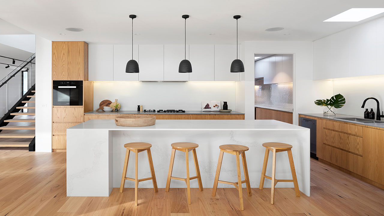 Image of white kitchen cabinets with bare wood elements.