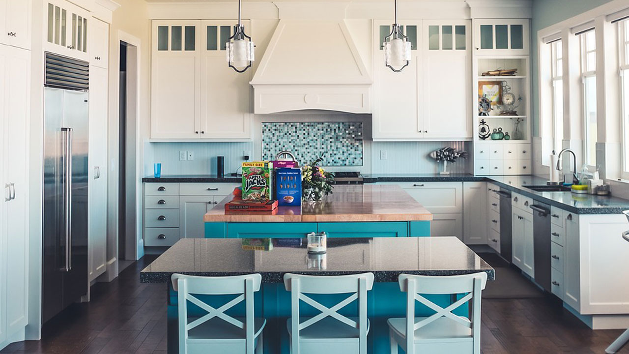 Image of a kitchen with white cabinets with blue color elements around.