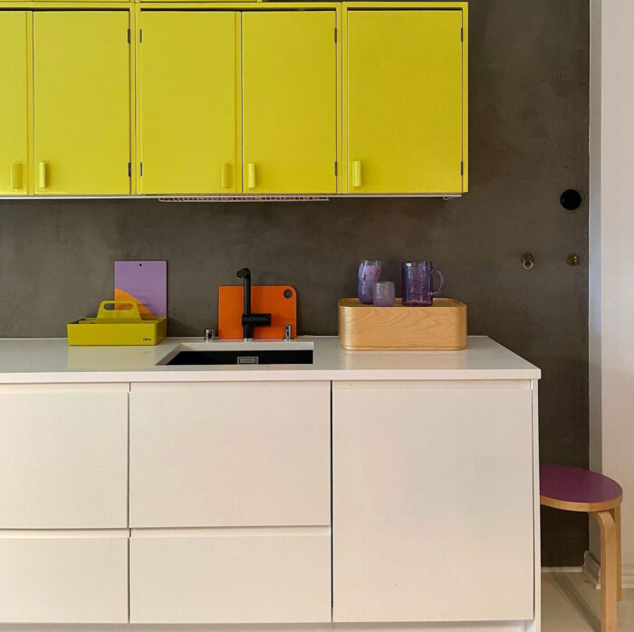 Beige and yellow cabinets near a grey wall