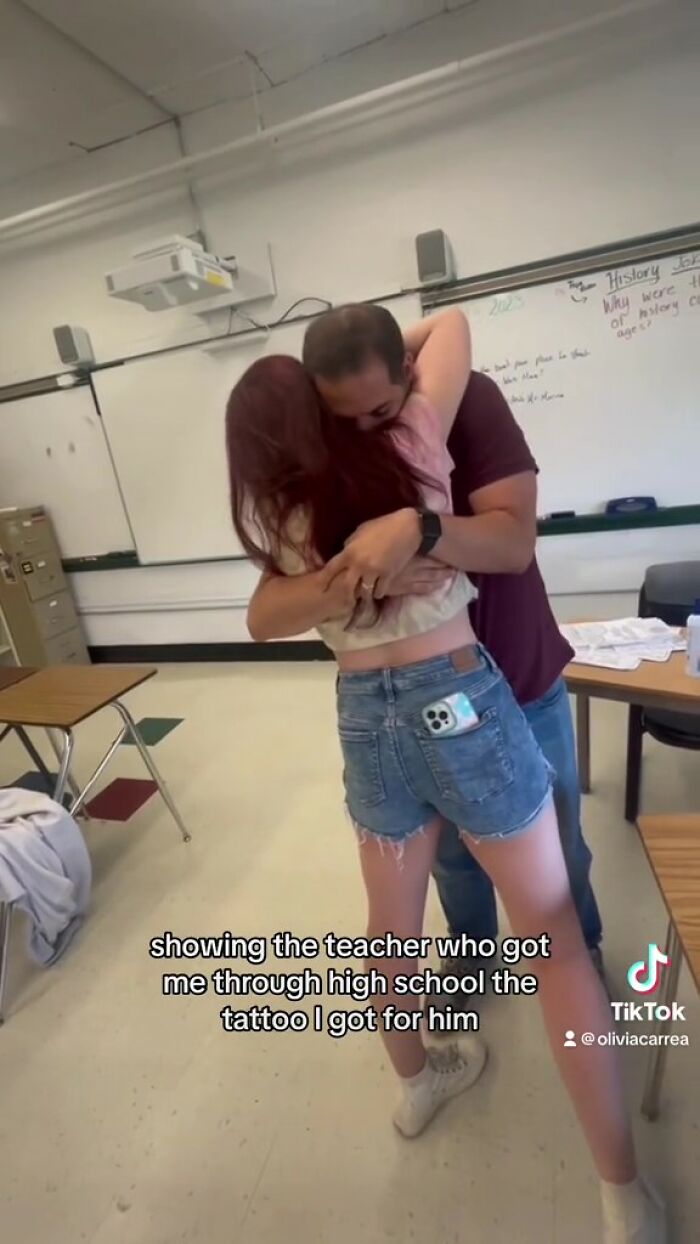 Student hugging teacher after getting meaningful handwritten tattoo. Student hugging teacher after getting meaningful handwritten tattoo.