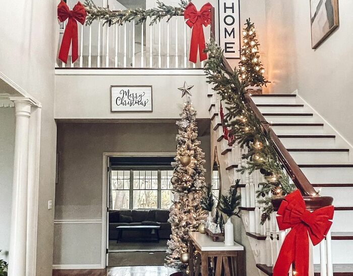 Staircase decorated by evergreen garlands
