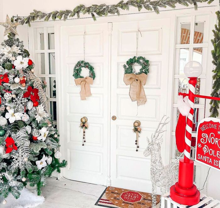Christmas tree near the door with two wreaths