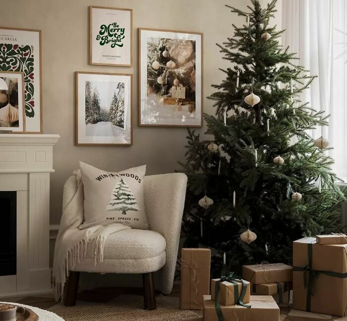 Cozy armchair with cover and pillow near christmas tree