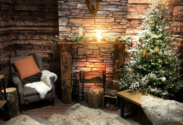 Grey rug near christmas tree and fireplace