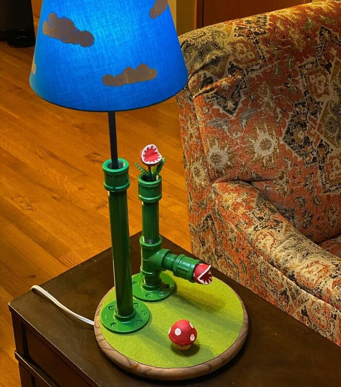 Super Mario lamp on the table next to a couch 