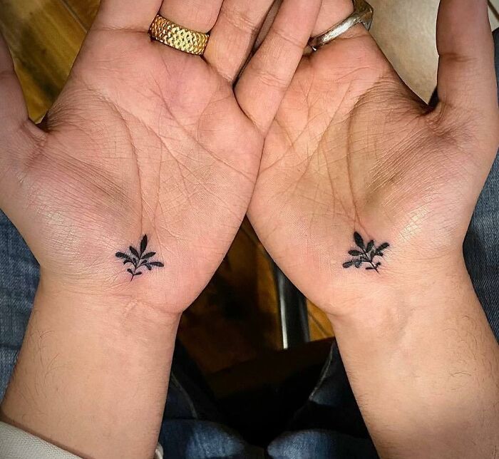 Floral decorative black small tattoos on hand palms